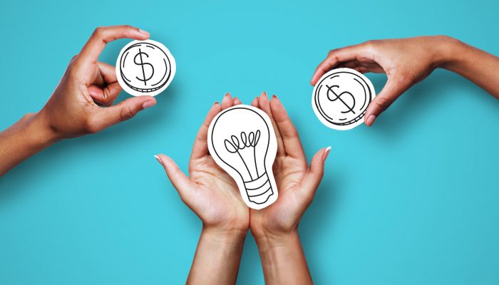 Hands with dollar sign coins and light bulb, against a blue background, representing financing